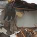 An excavator demolishes a townhouse in Liberty Square.